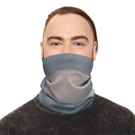 Person wearing a gray neck gaiter on a white background